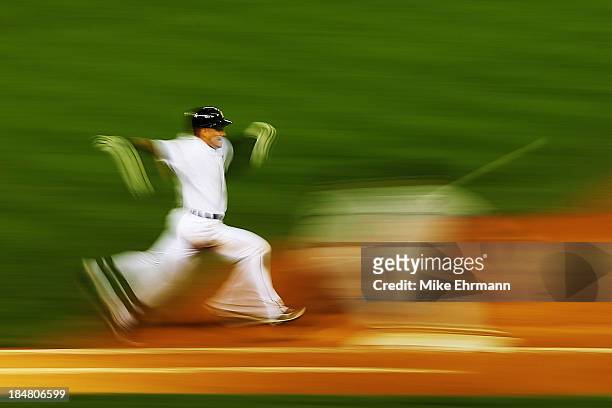 Jose Iglesias of the Detroit Tigers runs to first on a fielder's choice in the sixth inning against the Boston Red Sox during Game Four of the...