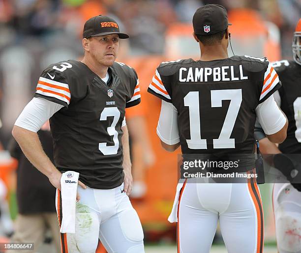 Quarterback Brandon Weeden talks to quarterback Jason Campbell of the Cleveland Browns on the sideline during a game against the Detroit Lions at...