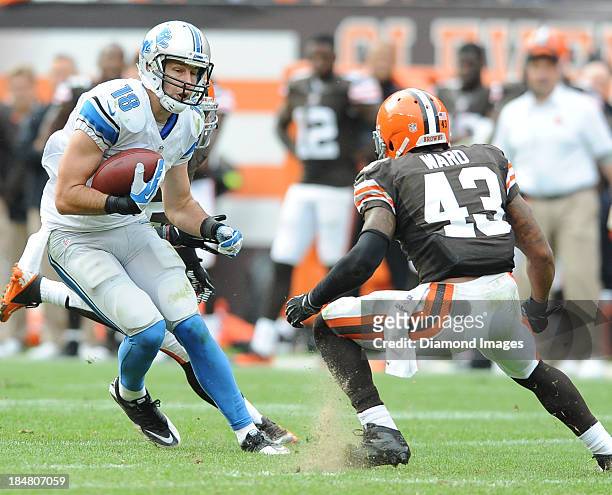 Receiver Kris Durham of the Detroit Lions runs away from defensive back T.J. Ward of the Cleveland Browns during a game against the Cleveland Browns...