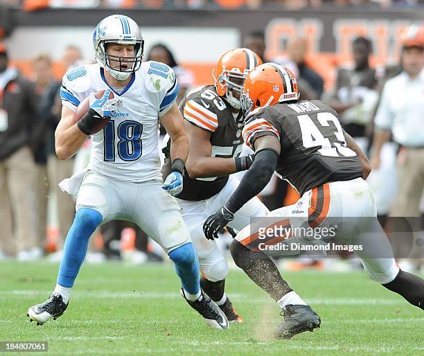 Receiver Kris Durham of the Detroit Lions runs away from defensive back T.J. Ward of the Cleveland Browns during a game against the Cleveland Browns...