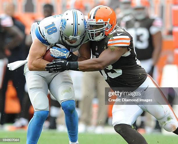 Receiver Kris Durham of the Detroit Lions is tackled by linebacker Craig Robertson of the Cleveland Browns during a game against the Cleveland Browns...