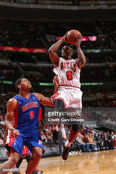 Mike James of the Chicago Bulls shoots against Tony Mitchell of the Detroit Pistons on October 16, 2013 at the United Center in Chicago, Illinois....