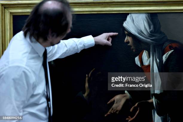 Master restorer Paolo Violini shows a detail of a restored painting at Vatican Museums Restoration Laboratory during “Beyond the surface. The...