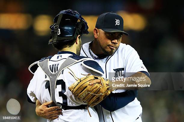 Joaquin Benoit and Alex Avila of the Detroit Tigers celebrate their 7 to 3 win over the Boston Red Sox in Game Four of the American League...