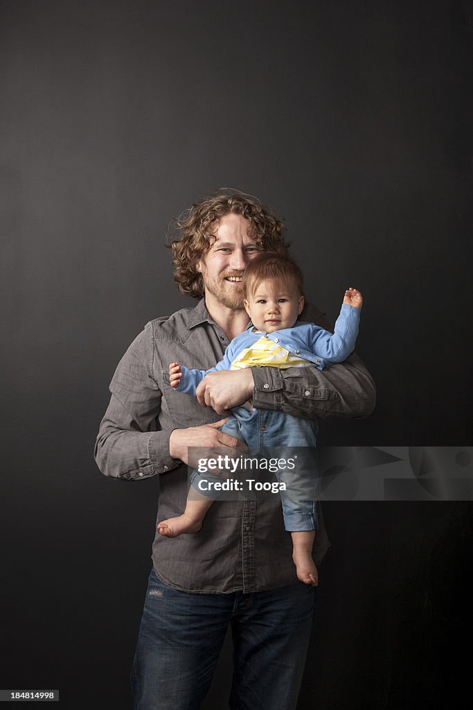 Father holding daughter for portriat