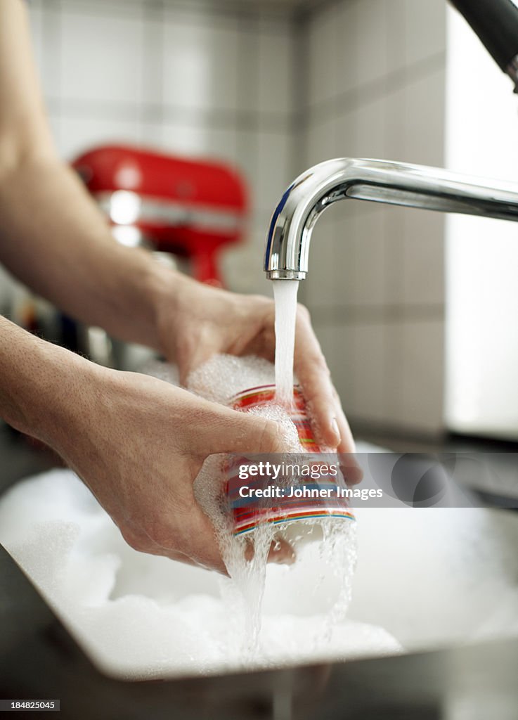 Close-up of woman washing dishes