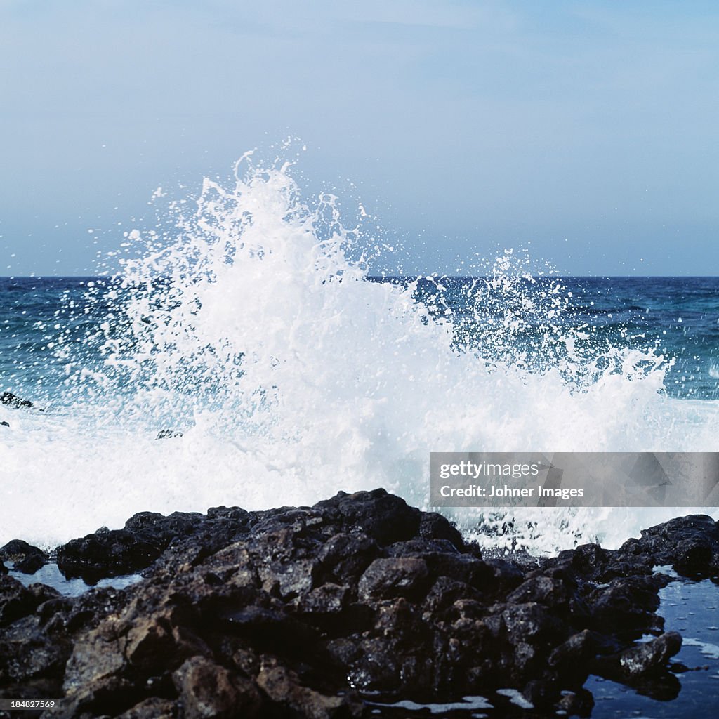 Wave crashing against rock