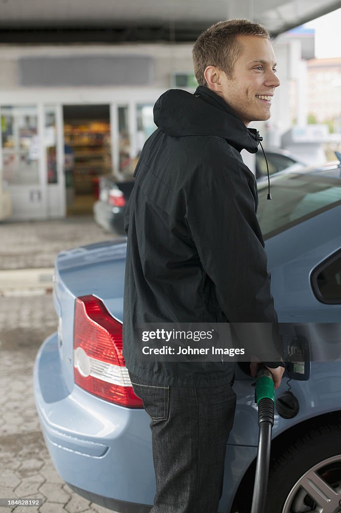 Man filling car with gas