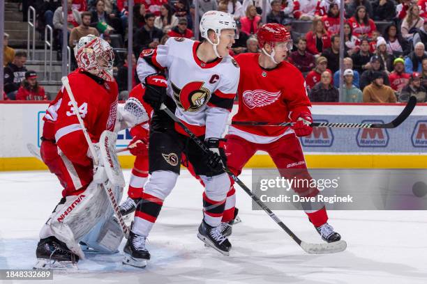 Brady Tkachuk of the Ottawa Senators follows the play between Alex Lyon and Olli Maatta of the Detroit Red Wings during the second period at Little...