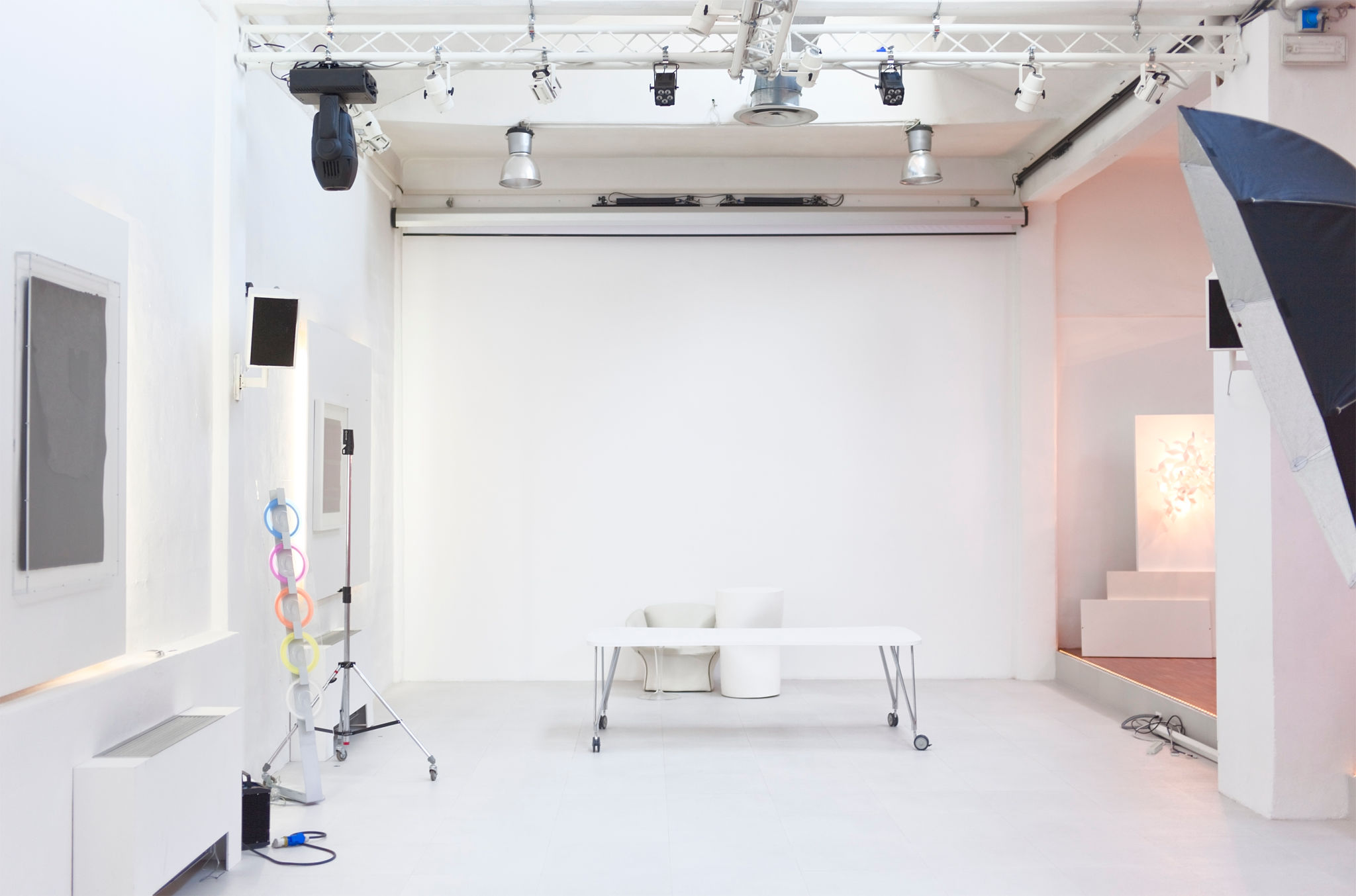 Empty white photographic studio with photo equipment. Empty white photographic studio with photo equipment.
