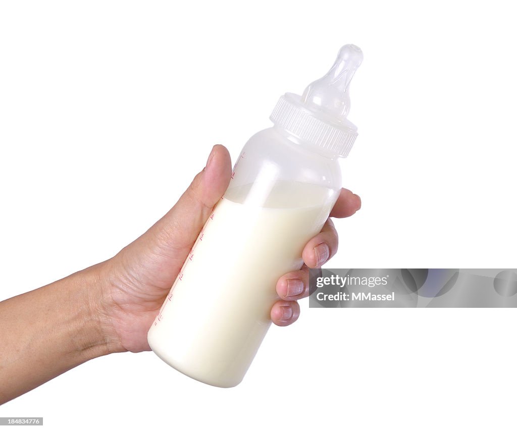 Bottle of baby milk on white