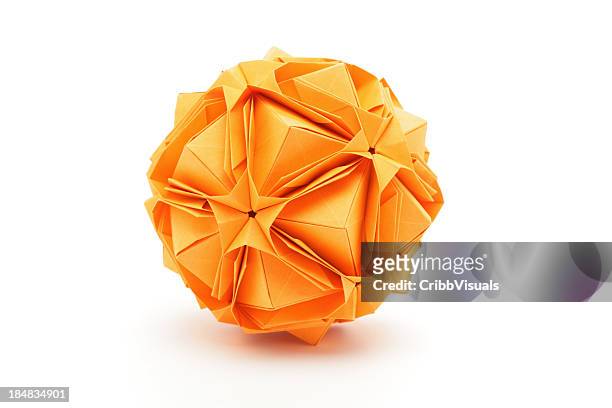 one orange origami polyhedron paper craft design - origami stock pictures, royalty-free photos & images