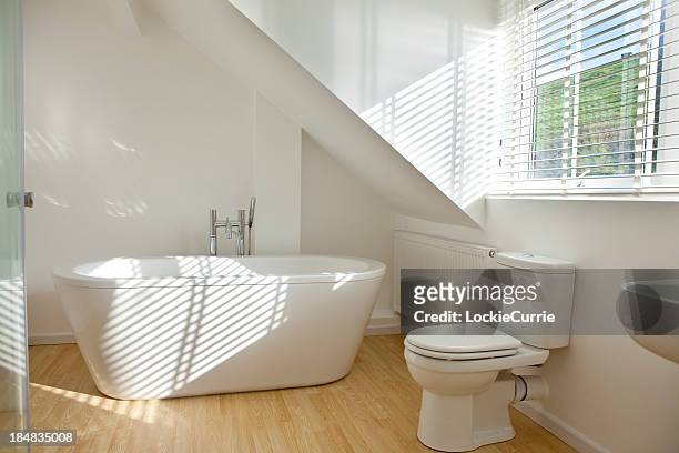modern white bathroom with toilet and sink - new bathtub stock pictures, royalty-free photos & images