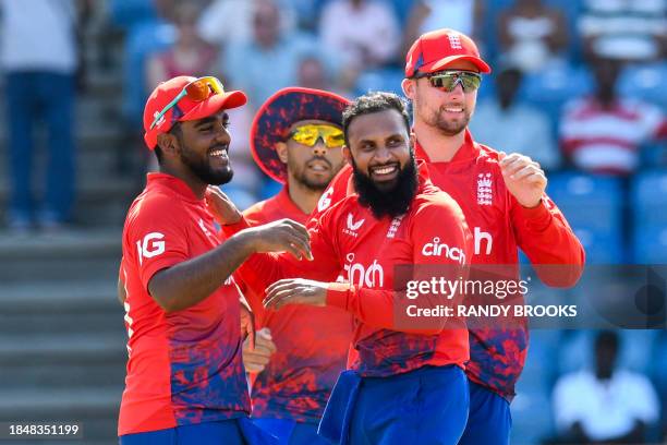 Rehan Ahmed , Adil Rashid , Tymal Mills and Will Jacks of England celebrate the dismissal of Nicholas Pooran of West Indies during the 2nd T20I...