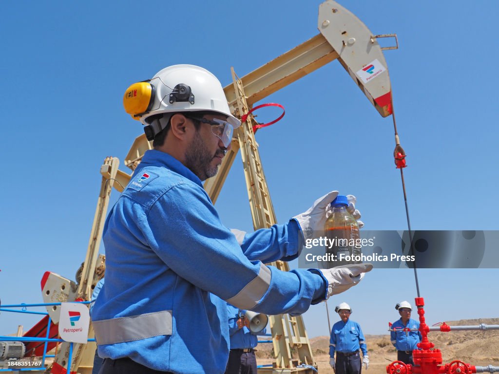 Petroperu personnel extracting a sample of crude from an oil...