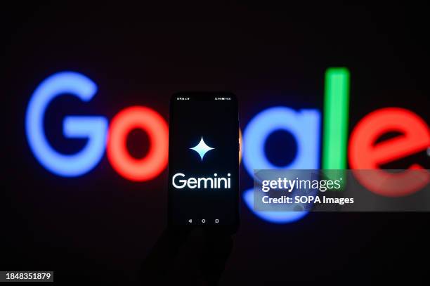 In this photo illustration a Google gemini logo is displayed on a smartphone with stock market percentages in the background.