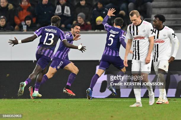 Toulouse's Chilean midfielder Gabriel Suazo celebrates with Toulouse's French defender Christian Mawissa Elebi and Toulouse's Australian midfielder...