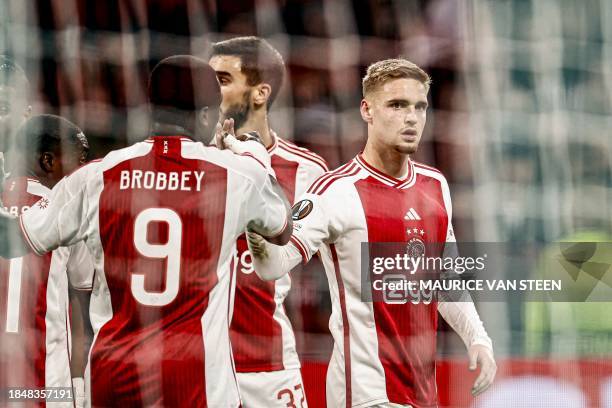 Ajax's Dutch forward Brian Brobbey and Ajax's Dutch midfielder Kenneth Taylor celebrate their team's second goal during the UEFA Europa League Group...