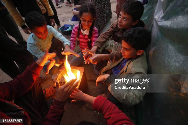 Palestinians struggle with cold weather as they stay in the makeshift tents they set up near Al Aqsa Martyrs Hospital in Deir al Balah, Gaza on...