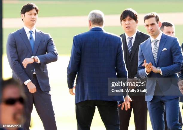Shohei Ohtani, from left, stands with his translator Ippeei Mizuhara and announcer Joe Davis before the Los Angeles Dodgers introduce Ohtani as the...