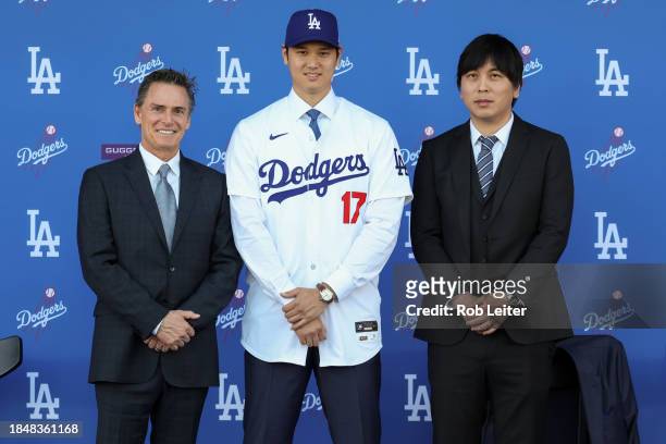 Agent Nez Balelo, Shohei Ohtani and Ippei Mizuhara pose for a photo during the Shohei Ohtani Los Angeles Dodgers Press Conference at Dodger Stadium...