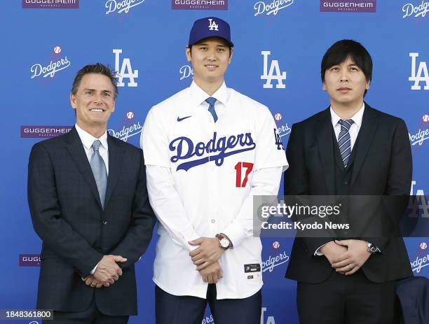 New Los Angeles Dodger Shohei Ohtani poses with his agent Nez Balelo and interpreter Ippei Mizuhara at an introductory press conference on Dec. 14 at...