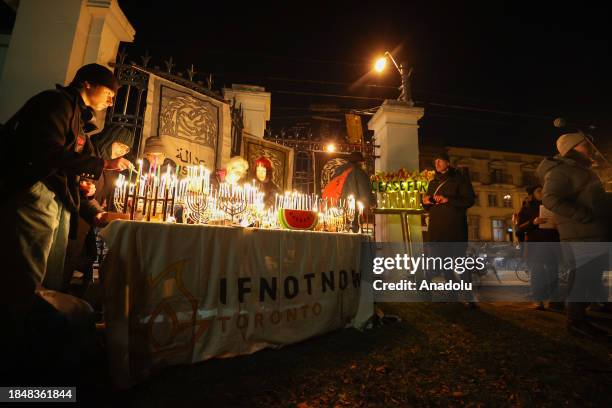 People gather to attend 'Hanukkah For Ceasefire' organized by Jewish community 'IfNotNow Toronto', on the last night of Hanukkah at Trinity Bellwoods...