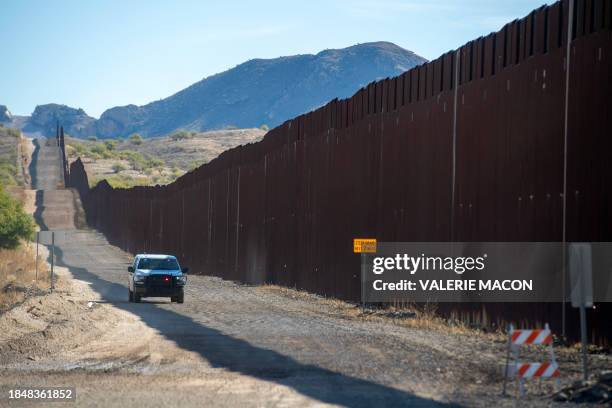 Customs and Border Protection vehicle drives alongside the US-Mexico border wall in Sasabe, Arizona, on December 8, 2023. Jaguars don't understand...