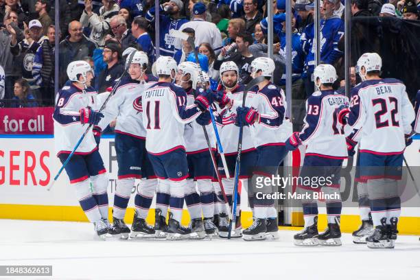 The Columbus Blue Jackets celebrate after defeating the Toronto Maple Leafs in overtime at the Scotiabank Arena on December 14, 2023 in Toronto,...