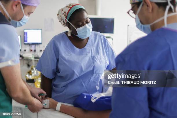 French doctor Aicha N'Doye, a breast cancer surgeon who sings before her operations, sings to soothe a patient during anesthesia prior to surgery, in...