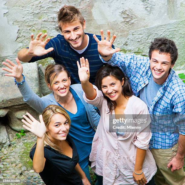 friends waving hands together to welcome - clique stock pictures, royalty-free photos & images