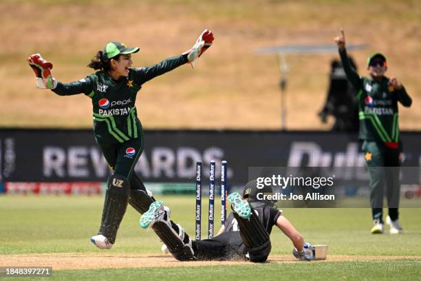 Bernadine Bezuidenhout of New Zealand is run out by Aliya Riaz and Najiha Alvi of Pakistan during game one of the Women's ODI series between New...