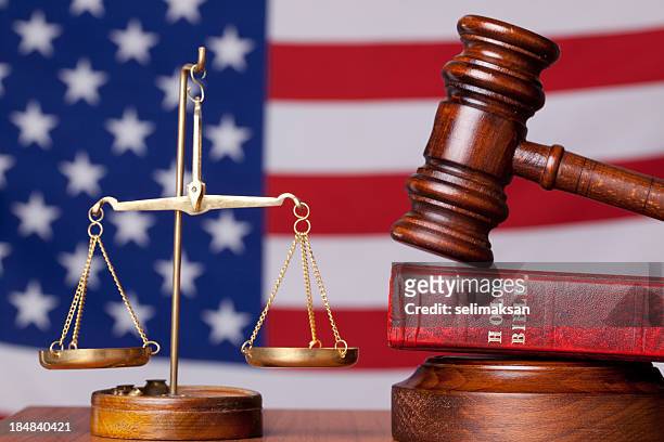 bible, gavel and scales of justice on american flag background - religion stock pictures, royalty-free photos & images