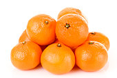 Pile of bright fresh tangerine fruits on a white background