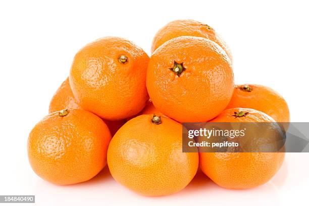 pile of bright fresh tangerine fruits on a white background - mandarine stock pictures, royalty-free photos & images