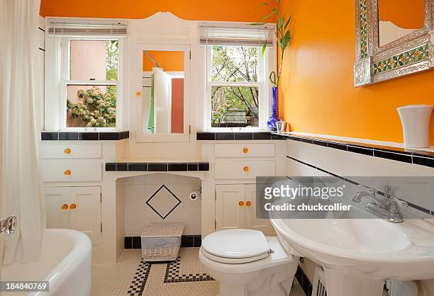 bright orange and white colorful modern bathroom - brightly lit bathroom stock pictures, royalty-free photos & images
