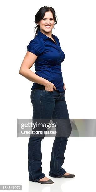 happy young woman standing with hands in pockets - blue blouse stock pictures, royalty-free photos & images