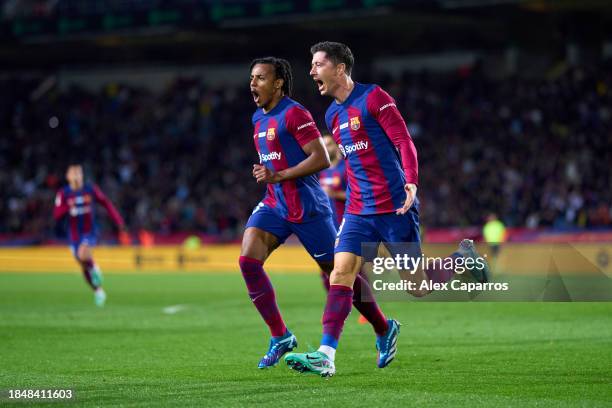 Robert Lewandowski of FC Barcelona celebrates with his teammate Jules Kounde after scoring their team's first goal during the LaLiga EA Sports match...
