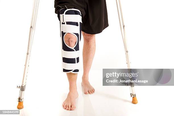 men knee after surgery with brace - knee brace stock pictures, royalty-free photos & images