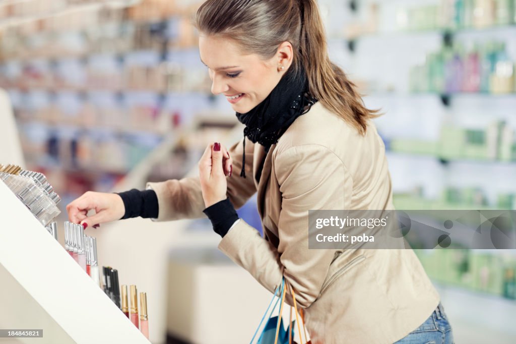 Girl  purchases cosmetics in the beauty shop