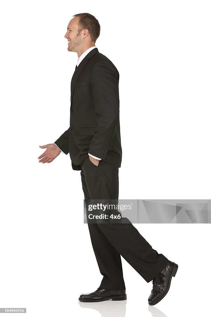 Side view of a businessman walking