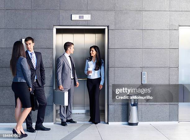 business people outside the elevator - outside elevator stock pictures, royalty-free photos & images