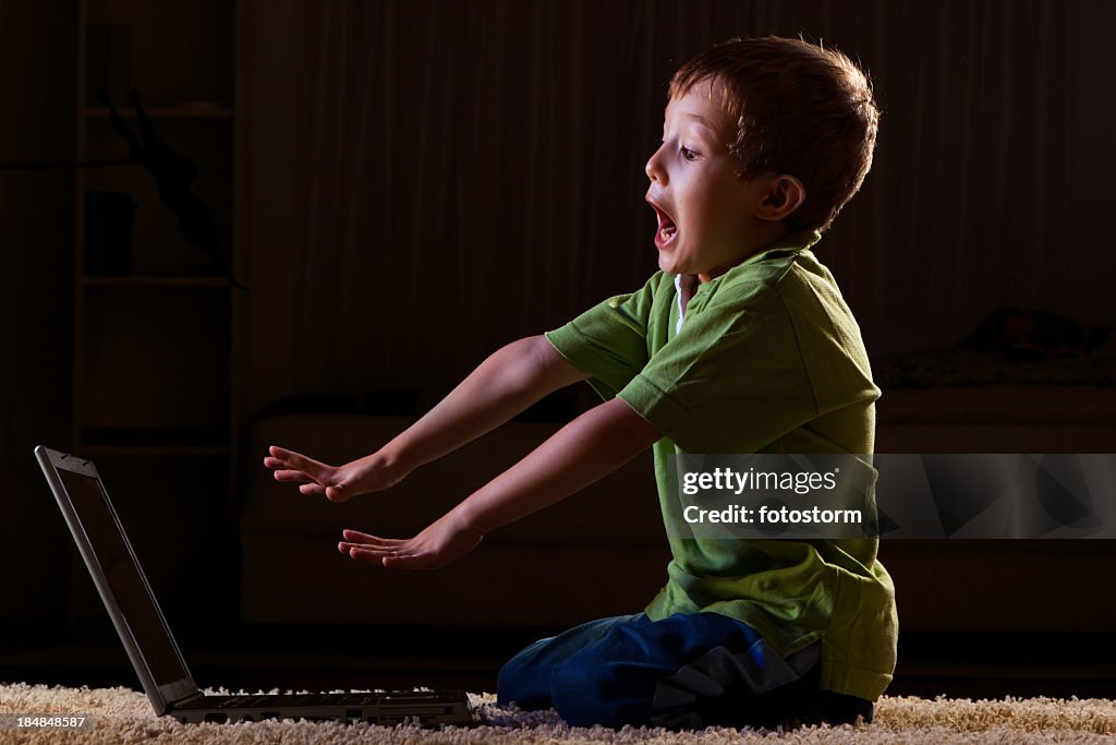 Kid Crying At Computer Scared Child In Front Of The Laptop High-Res Stock Photo - Getty Images
