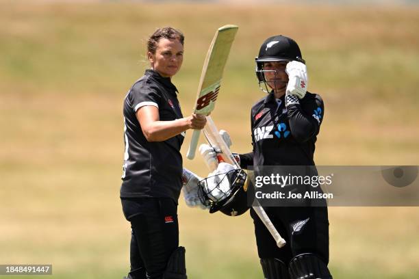 Suzie Bates of New Zealand raises her bat after scoring a century during game one of the Women's ODI series between New Zealand and Pakistan at John...