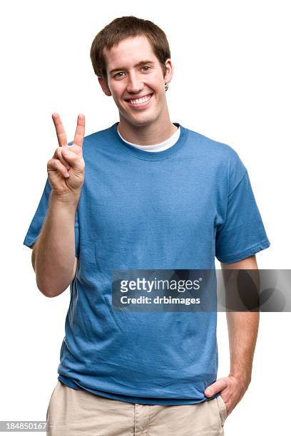 grinning young man gives peace sign - two fingers stock pictures, royalty-free photos & images