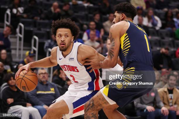 Cade Cunningham of the Detroit Pistons tries to drive around Obi Toppin of the Indiana Pacers during the first half at Little Caesars Arena on...