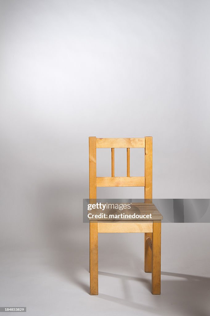 Wooden chair on gray background.