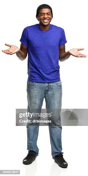 shrugging young man smiling - schouders ophalen stockfoto's en -beelden