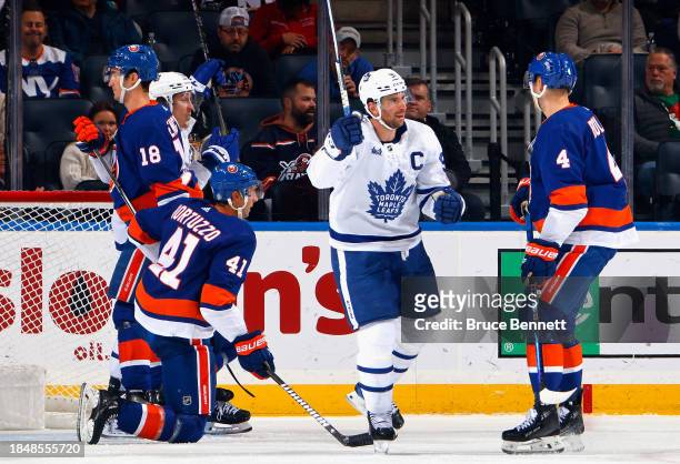 John Tavares of the Toronto Maple Leafs celebrates his goal at 7:43 of the second period against the New York Islanders at UBS Arena on December 11,...
