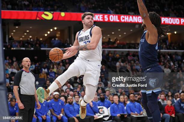 Luka Doncic of the Dallas Mavericks looks to pass against Derrick Rose of the Memphis Grizzlies during the first half at FedExForum on December 11,...